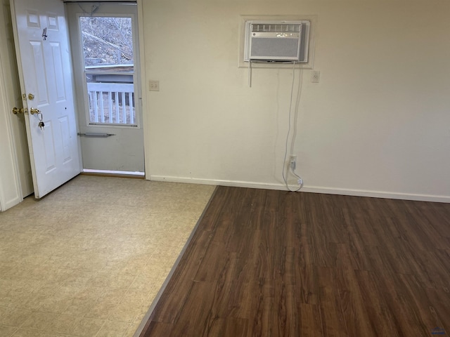 1111 Silver St, Rapid City, SD 57701 - empty room featuring tile patterned floors, a wall unit AC, and baseboards