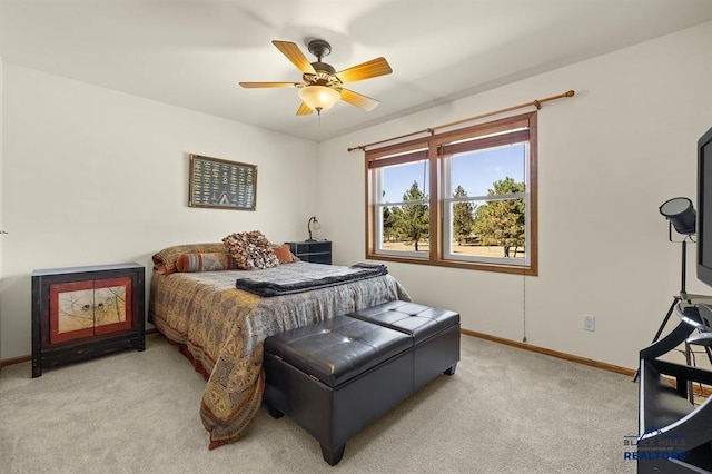 bedroom with light carpet, baseboards, and a ceiling fan