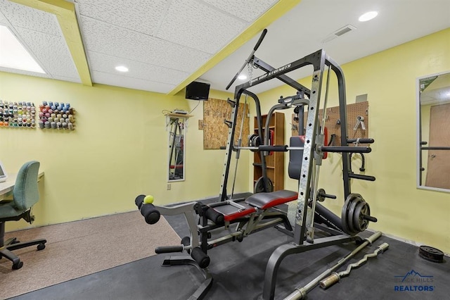 exercise area with visible vents, a paneled ceiling, and recessed lighting