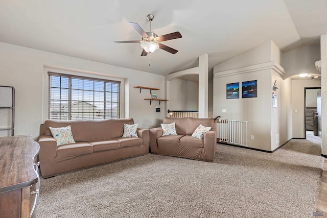 living area featuring vaulted ceiling, carpet flooring, radiator heating unit, baseboards, and ceiling fan
