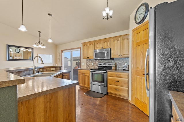 kitchen with a sink, a notable chandelier, tasteful backsplash, and appliances with stainless steel finishes