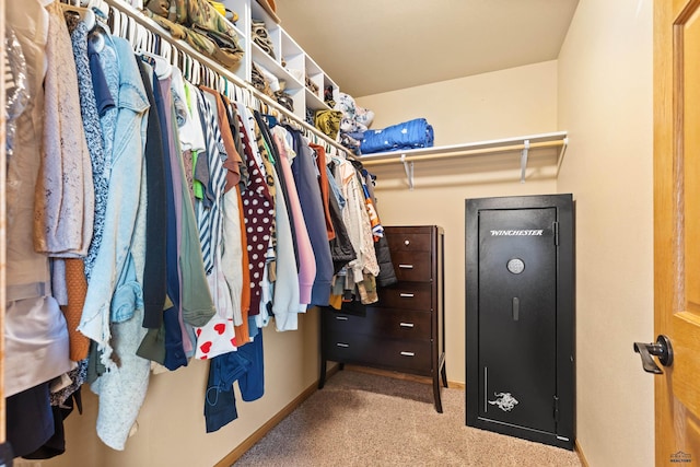 walk in closet with carpet
