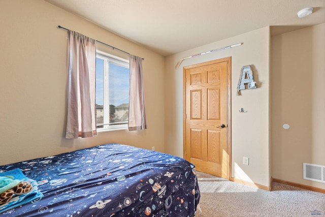carpeted bedroom featuring baseboards and visible vents
