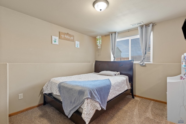 carpeted bedroom with baseboards and visible vents