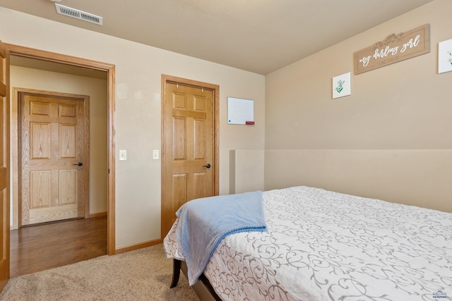 carpeted bedroom with baseboards and visible vents