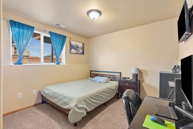 bedroom with carpet floors, baseboards, and visible vents