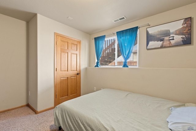 carpeted bedroom with baseboards and visible vents