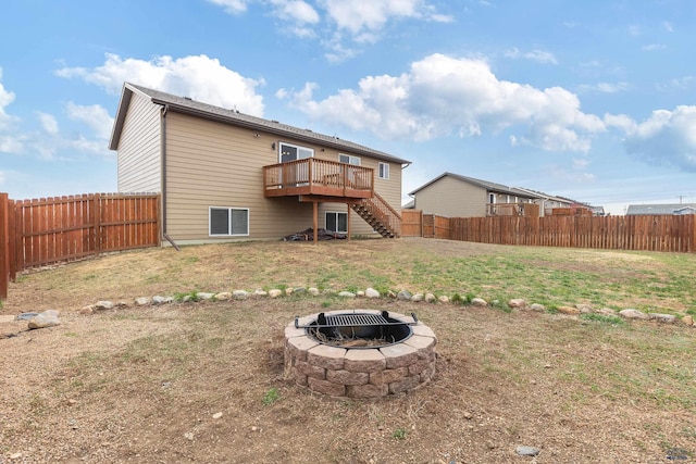 rear view of house featuring a fenced backyard, stairway, and a deck