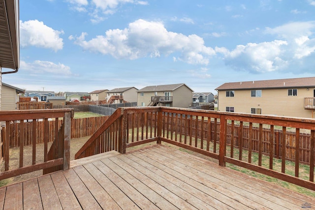 wooden deck featuring a fenced backyard and a residential view