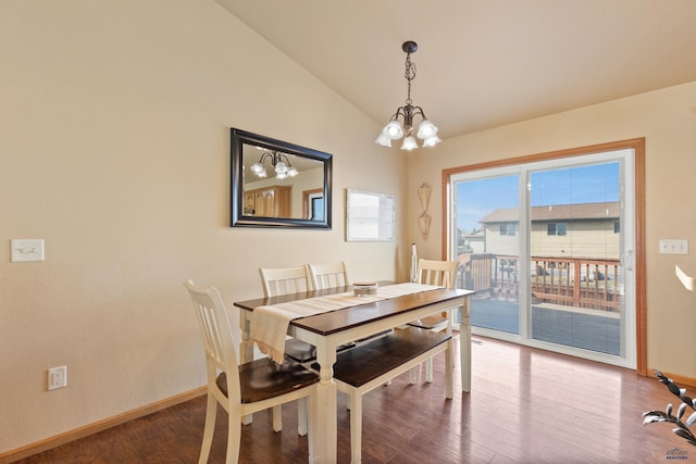 dining area featuring a notable chandelier, baseboards, vaulted ceiling, and wood finished floors