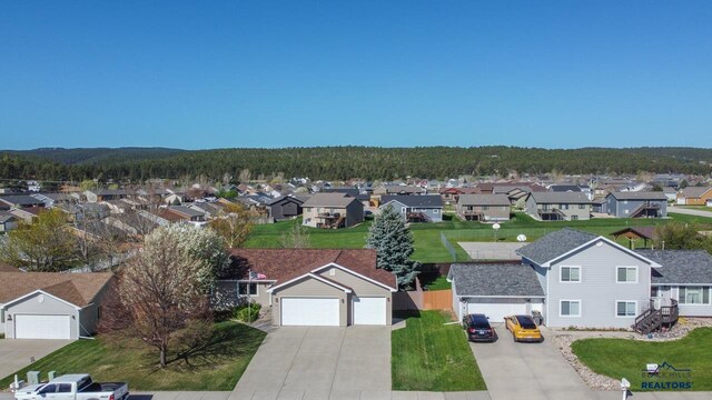 aerial view of residential area with a heavily wooded area