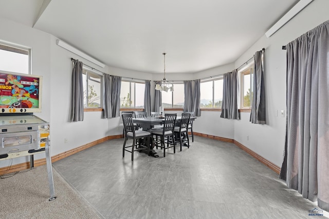 23863 Emerald Pines Dr, Hill City, SD 57745 - dining space featuring baseboards and a notable chandelier
