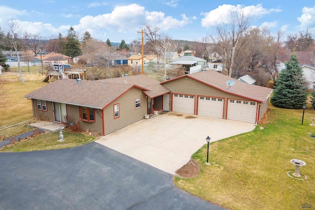 4024 W Main, Rapid City, SD 57702 - ranch-style house featuring a front lawn, concrete driveway, roof with shingles, and a residential view