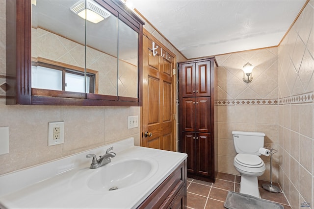 4024 W Main, Rapid City, SD 57702 - bathroom with tile patterned flooring, vanity, toilet, and tile walls