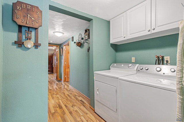 4024 W Main, Rapid City, SD 57702 - clothes washing area with baseboards, cabinet space, washing machine and dryer, and light wood-style floors