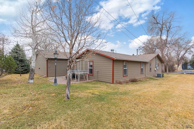 4024 W Main, Rapid City, SD 57702 - back of property featuring a trampoline, a lawn, roof with shingles, and a patio area