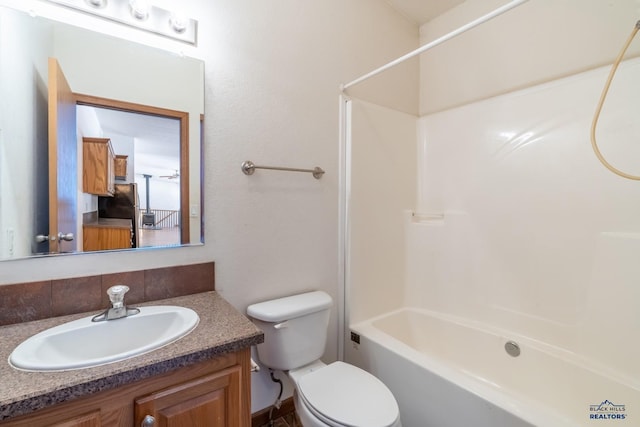 bathroom with bathtub / shower combination, toilet, backsplash, and vanity
