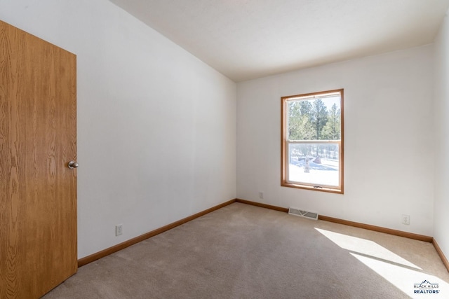 carpeted empty room with baseboards and visible vents