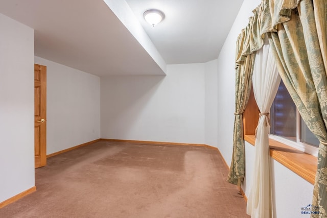 bonus room featuring carpet flooring and baseboards