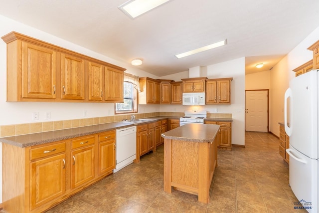 kitchen with a sink, a center island, lofted ceiling, brown cabinetry, and white appliances