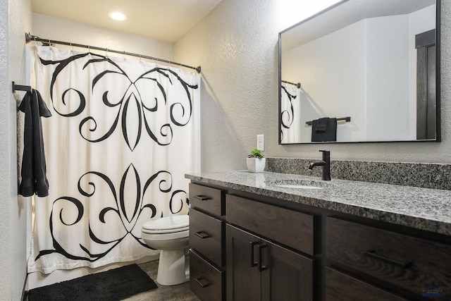 21260 Ridgewood Trl, Lead, SD 57754 - full bathroom with toilet, vanity, a textured wall, and shower / bath combo with shower curtain