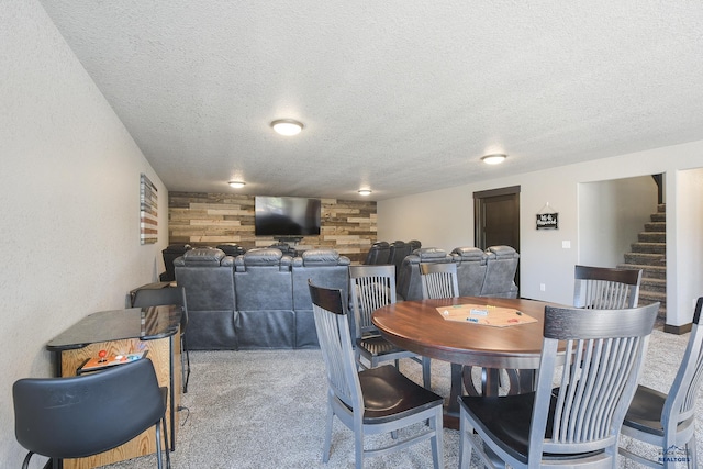 21260 Ridgewood Trl, Lead, SD 57754 - dining area featuring stairs, wood walls, carpet flooring, and a textured ceiling