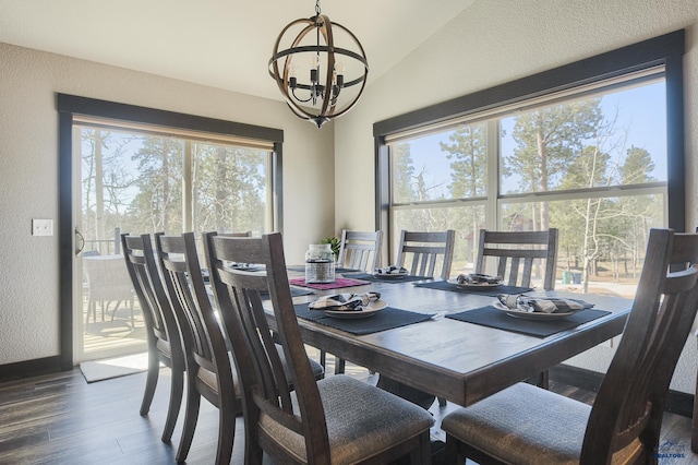 21260 Ridgewood Trl, Lead, SD 57754 - dining room featuring lofted ceiling, a textured wall, baseboards, a chandelier, and wood finished floors
