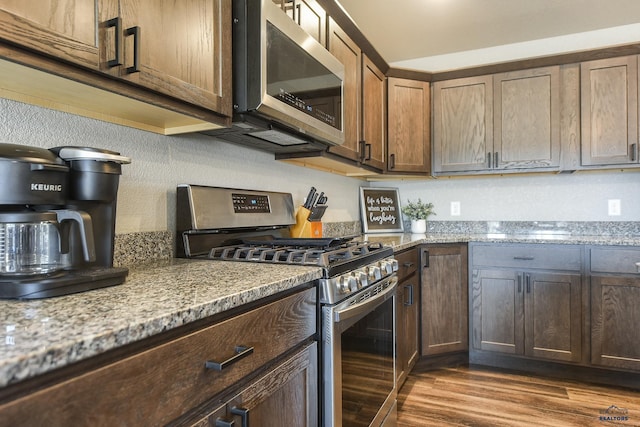 21260 Ridgewood Trl, Lead, SD 57754 - kitchen featuring dark wood-type flooring, light stone countertops, and stainless steel appliances