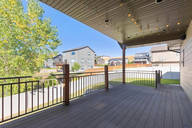 deck with fence and a residential view