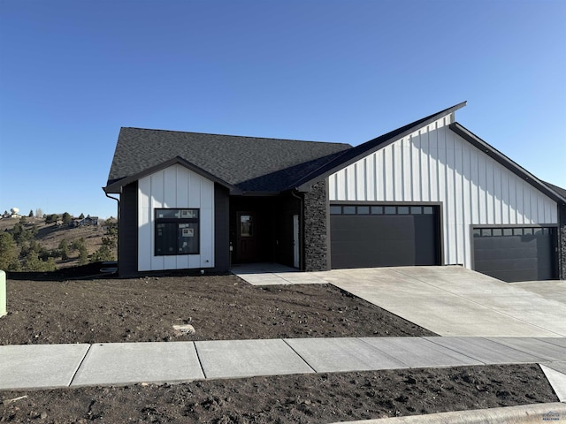 1230 Pinnacle Ct, Rapid City, SD 57701 - modern inspired farmhouse with an attached garage, board and batten siding, concrete driveway, and roof with shingles