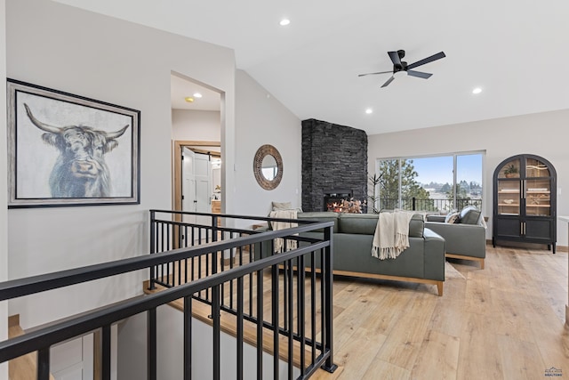 1230 Pinnacle Ct, Rapid City, SD 57701 - living room featuring vaulted ceiling, ceiling fan, light wood-style flooring, a fireplace, and recessed lighting