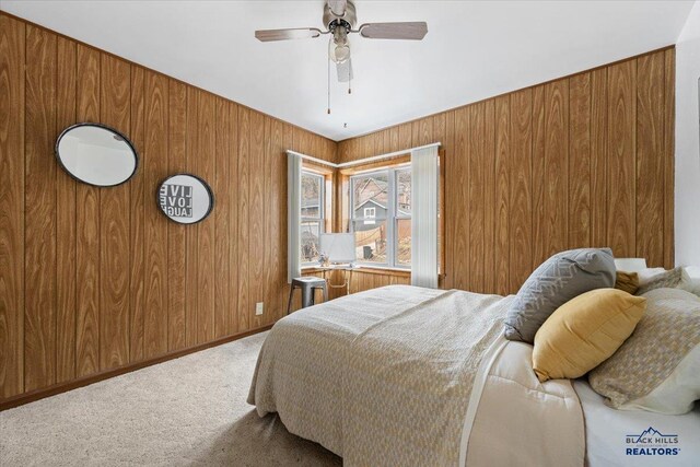 37 Washington St, Deadwood, SD 57732 - carpeted bedroom with a ceiling fan, baseboards, and wooden walls