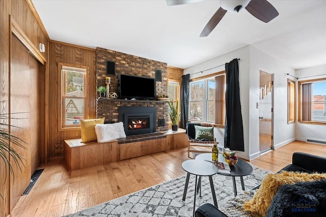 37 Washington St, Deadwood, SD 57732 - living area with visible vents, a brick fireplace, hardwood / wood-style flooring, baseboards, and a ceiling fan