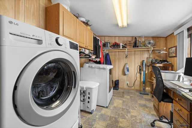 37 Washington St, Deadwood, SD 57732 - laundry room featuring stone finish floor, washer / dryer, and wooden walls
