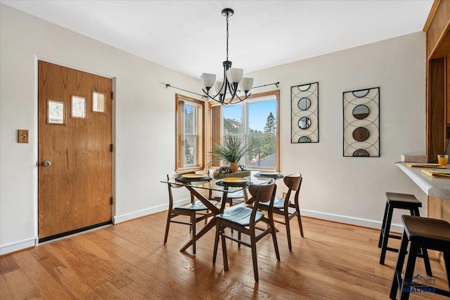 37 Washington St, Deadwood, SD 57732 - dining room with a notable chandelier, baseboards, and wood finished floors