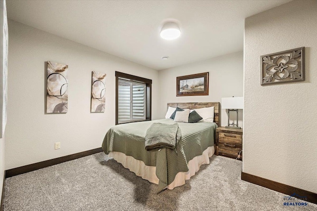 carpeted bedroom featuring baseboards