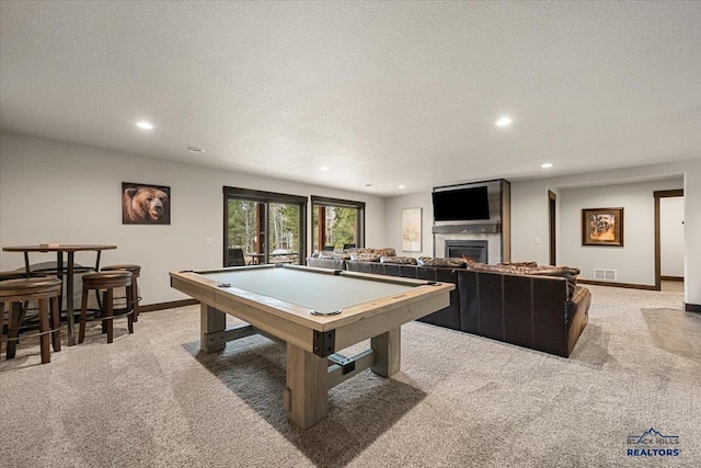 rec room with a glass covered fireplace, pool table, light colored carpet, and visible vents
