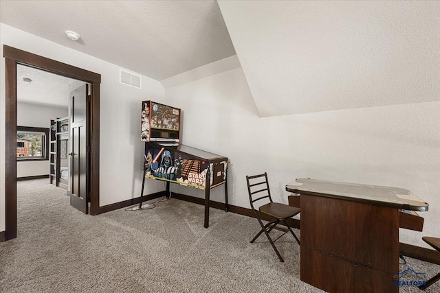 carpeted office featuring baseboards, a textured ceiling, and visible vents