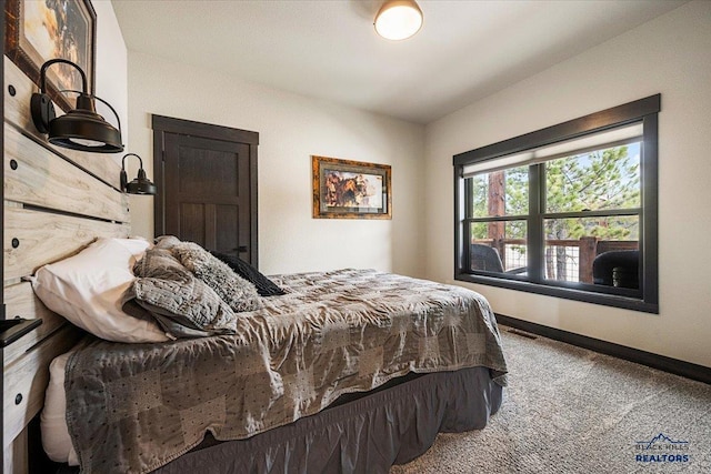 bedroom featuring baseboards, carpet flooring, and visible vents