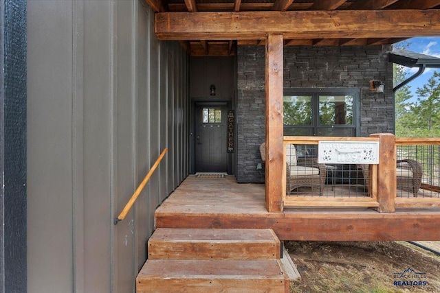 property entrance with stone siding