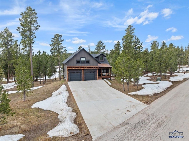 rustic home with board and batten siding, driveway, and a garage