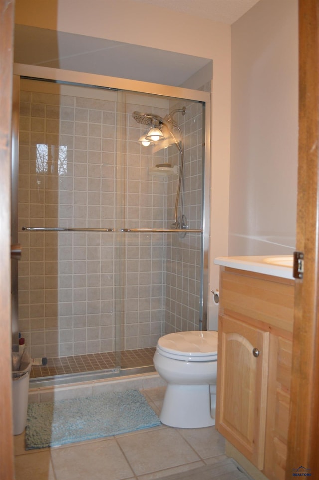 1521 Forest Ct, Rapid City, SD 57701 - bathroom featuring toilet, tile patterned floors, a shower stall, and vanity