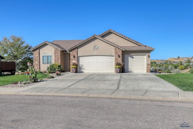 4153 Augusta Dr, Rapid City, SD 57703 - single story home featuring a garage, concrete driveway, a tile roof, brick siding, and a front lawn