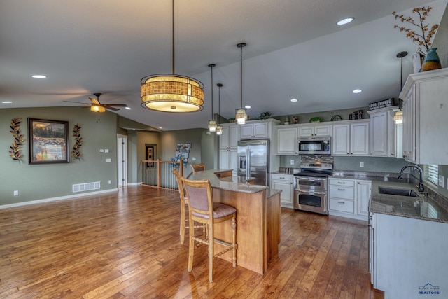 4153 Augusta Dr, Rapid City, SD 57703 - kitchen with a sink, lofted ceiling, stainless steel appliances, visible vents, and ceiling fan