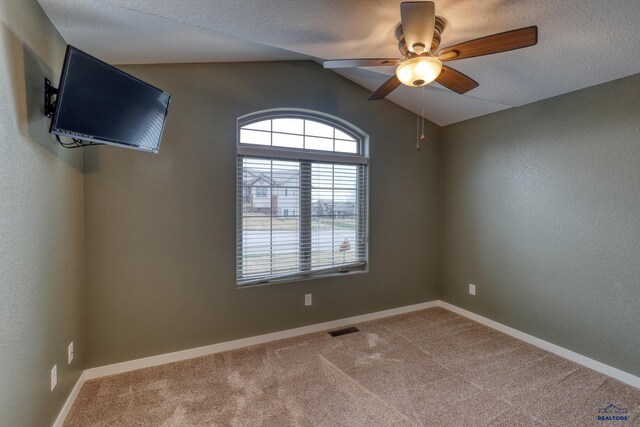 4153 Augusta Dr, Rapid City, SD 57703 - carpeted empty room featuring baseboards, visible vents, vaulted ceiling, and a ceiling fan