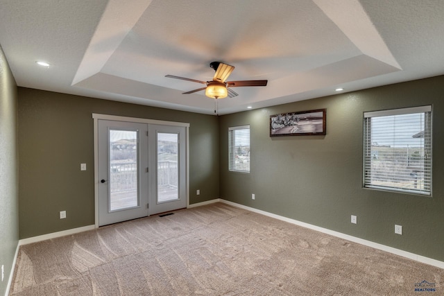 4153 Augusta Dr, Rapid City, SD 57703 - empty room with light colored carpet, baseboards, a raised ceiling, visible vents, and a ceiling fan