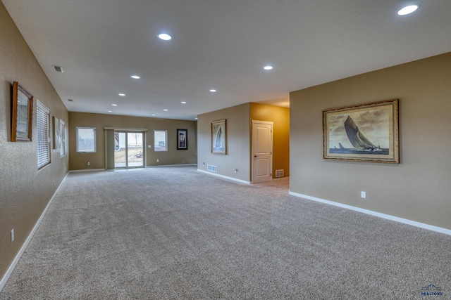 4153 Augusta Dr, Rapid City, SD 57703 - unfurnished living room with baseboards, visible vents, light colored carpet, and recessed lighting