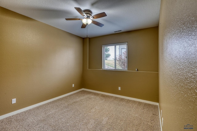 4153 Augusta Dr, Rapid City, SD 57703 - carpeted spare room featuring baseboards, a textured ceiling, a textured wall, and a ceiling fan