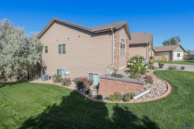 4153 Augusta Dr, Rapid City, SD 57703 - view of property exterior featuring a lawn and cooling unit