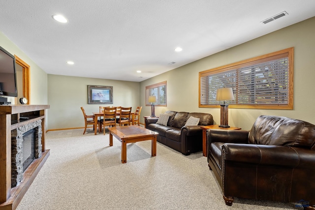 24354 Rushmore Ranch Rd, Keystone, SD 57751 - living room featuring light colored carpet, recessed lighting, baseboards, visible vents, and a fireplace